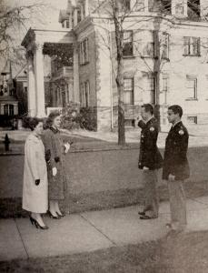Merciad file photo: ROTC seniors at Gannon College, Ted White and Mike Annunciata, show Mary Kay Walsh and Mary Ann Bittner, junior and senior students of Mercyhurst, the recently purchased Student Union Building. This Student Center, located on the corner of 6th and Walnut Streets, is to be furnished partially by the proceeds of the forthcoming Christmas Carnival, to be held in Gannon Audi, December 14, 15 and 16.